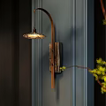 Rustic Wooden Wall Lamp On Vertical Striped Blue Wall With Warm Light And Green Branches