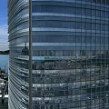 Aerial Planning of Modern Glass Curtain Wall Skyscraper with Urban Landscape and Water Reflection