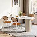 Modern Dining Table Set with Fluted Pedestal White Top and Rattan Back Orange Cushion Chairs