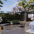 Tranquil Courtyard Garden With Cherry Blossom Tree Pavilion Water Feature And Lush Greenery