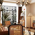 Warm Retro Open Living And Dining Room With Wooden Rattan Furniture And Large Bright Window