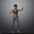 Woman Practicing Boxing Stance In Gray Sports Bra And Leggings