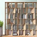 Modern Wooden Bookshelf with Grid Compartments and Decorative Items Near Green Plant