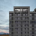 Modern High Rise Residential Building With Large Windows And Balconies Overlooking City View