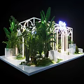 Floral Installation Featuring White Arched Frame Green Foliage Palm Leaves And Mossy Base