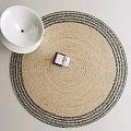 Beige Round Rug With Dark Border And Decorative Box Near White Ceramic Bowl