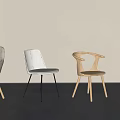 Four Different Designed Dining Chairs Arranged Against Light Colored Wall With Gray Floor