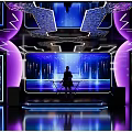 Futuristic Bar Interior With Purple Lighting Stage Neon Lights Background Screen And Person Silhouette
