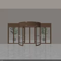 Modern Revolving Door With Bronze Frame Glass Panels And Potted Plants