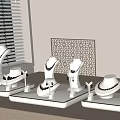 Chic Gold Jewelry Display On White Stands With Mannequins Necklaces Bracelets And Laser Cut Panel