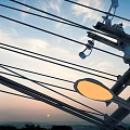 Road Infrastructure With Utility Poles And Power Lines Under Sunset Sky