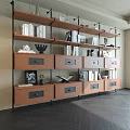 Sleek Modern Bookshelf With Wooden Shelves Drawers Books And Decorative Pieces