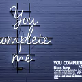 White Neon Decorative Light with You Complete Me on Blue Brick Wall and Black Frame