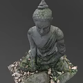 Stone Carved Buddha Sculpture In Sitting Posture With Moss And Fallen Leaves