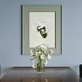 Framed Abstract Painting On Light Blue Wall With White Flower Vase And Green Elements