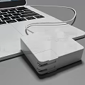Sleek Portable Laptop With Screen Showing App Icons And Connected Power Cable
