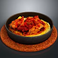 Braised Red Meat with Cabbage Over Yellow Mashed Potatoes in Black Bowl on Brown Mat