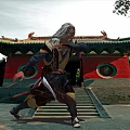 Man With White Hair Practicing Kung Fu In Front Of Red Walled Ancient Temple With Green Roof