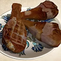 Roasted Chicken Legs On Floral Pattern Plate With Juicy Golden Brown Texture