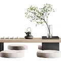 Modern Tea Table Set with Cushioned Stools Teapot Teacups and Green Plant