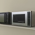 Two Modern Black and Silver Microwave Ovens Placed on White Shelf