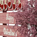 Romantic Valentine's Day Wooden Cart Decor With Pink Bouquet And Candies Desserts Drink Glasses