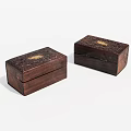 Two Carved Wooden Boxes With Golden Accents And Intricate Decorative Design