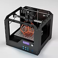 Black Frame 3D Printer Office Appliance With Orange Geometric Model On Build Plate Digital Screen
