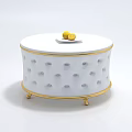 Elegant Modern Coffee Table With White Top Gold Trim And Decorative Lemons On Surface