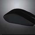 Sleek Dark Colored Wireless Mouse With Modern Ergonomic Design For Computers