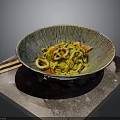 Yellow Noodles with Squid and Tomatoes in Textured Bowl and Chopsticks on Side