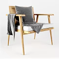 Modern Wooden Armchair With Grey Cushion And Blanket On Armrest