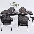 Outdoor Black Rattan Table And Chairs Set With Plant And Candle Holder Decor