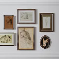 Wall Decor With Various Framed Artworks And Sketches On White Wall