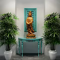 Elegant Console Table with Golden Guanyin Statue and Blue Carved Backdrop Flanked by Green Plants
