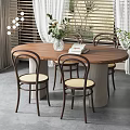 Round Wooden Dining Set With Curved Back Chairs Light Cushions White Vase Green Plants