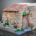 Miniature Stone House Model Featuring Red Tiled Roof Wooden Door Green Mailbox And Plants
