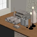 Gray Rolled Towels on Wooden Table with Aromatherapy Candles and Decorative Items