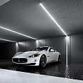 White Maserati Sports Car In Modern Garage With Gray Walls Strip Lights And Water Reflections