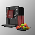 Black DeLonghi Coffee Machine With Red Cup And Fresh Fruit Platter In Kitchen