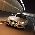 Silver Audi Car Driving On Road Through Illuminated Tunnel At Night