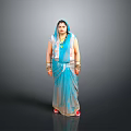 Woman Wearing Blue Sari with Gold Necklace and Bracelets on Shiny Floor