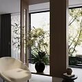 Indoor Potted Plant With White Flowers In Black Vase Near Beige Sofa And Large Window