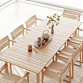 Natural Wooden Outdoor Table with Woven Chairs Vase Green Plant Teapot Tray and Teacups