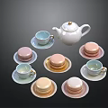 Colorful Macarons With White Teapot And Matching Teacups On Saucers For Afternoon Tea