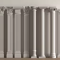 White Columns of Various Styles With Carved Capitals Arranged Against a Wall