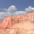 Colorful Danxia Landform With Red Orange Rock Formations Under Blue Sky And White Clouds