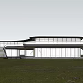 Modern Sales Office Building with Curved Glass Facade Surrounded by Grass Trees and Illuminated Interior
