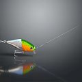 Colorful Fishing Lure With Green Yellow Silver Body And Fishing Line On Dark Background