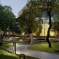 Serene Courtyard Garden With Lush Trees Green Grass Stone Paths And Warm Lighting